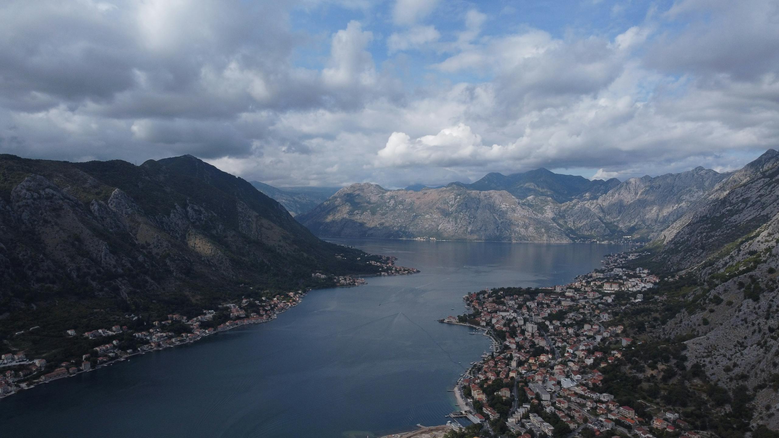 Stunning aerial shot of Kotor Bay with mountains and coastal towns in Montenegro.